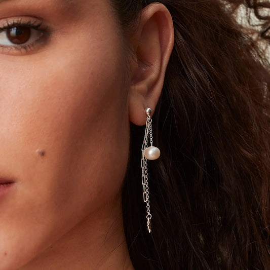 Pearl and sterling silver chain drop earrings worn on model
