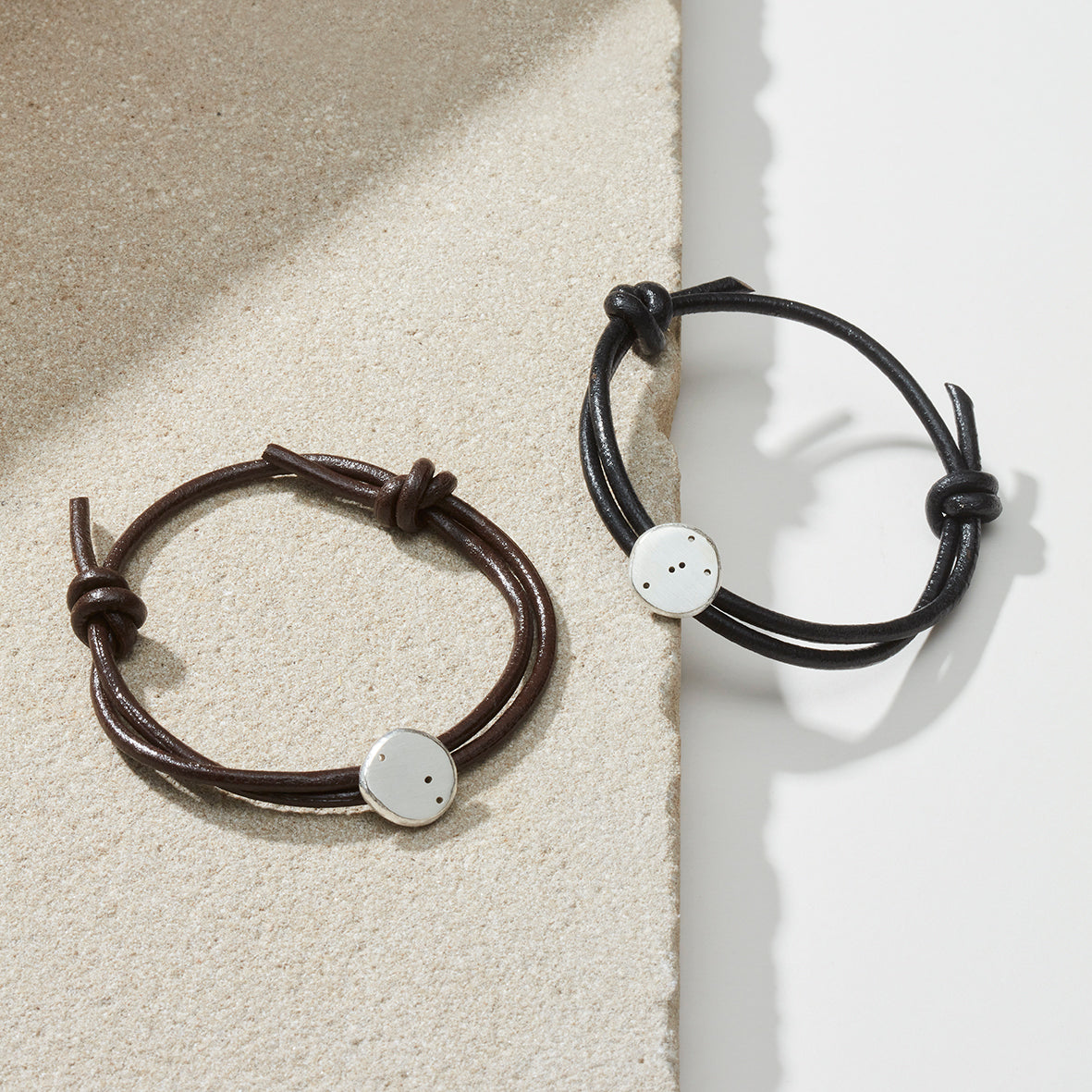 Star sign bracelets in black and brown leather with silver star sign charms representing taurus and aries star sign constellations