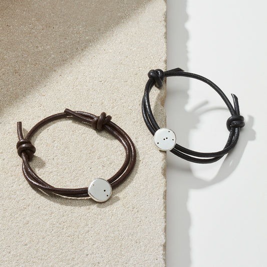 Star sign bracelets in black and brown leather with silver star sign charms representing taurus and aries star sign constellations