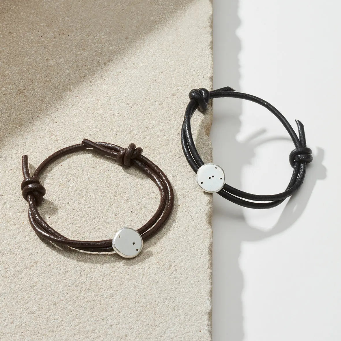 Star sign bracelets in black and brown leather with silver star sign charms representing taurus and aries star sign constellations
