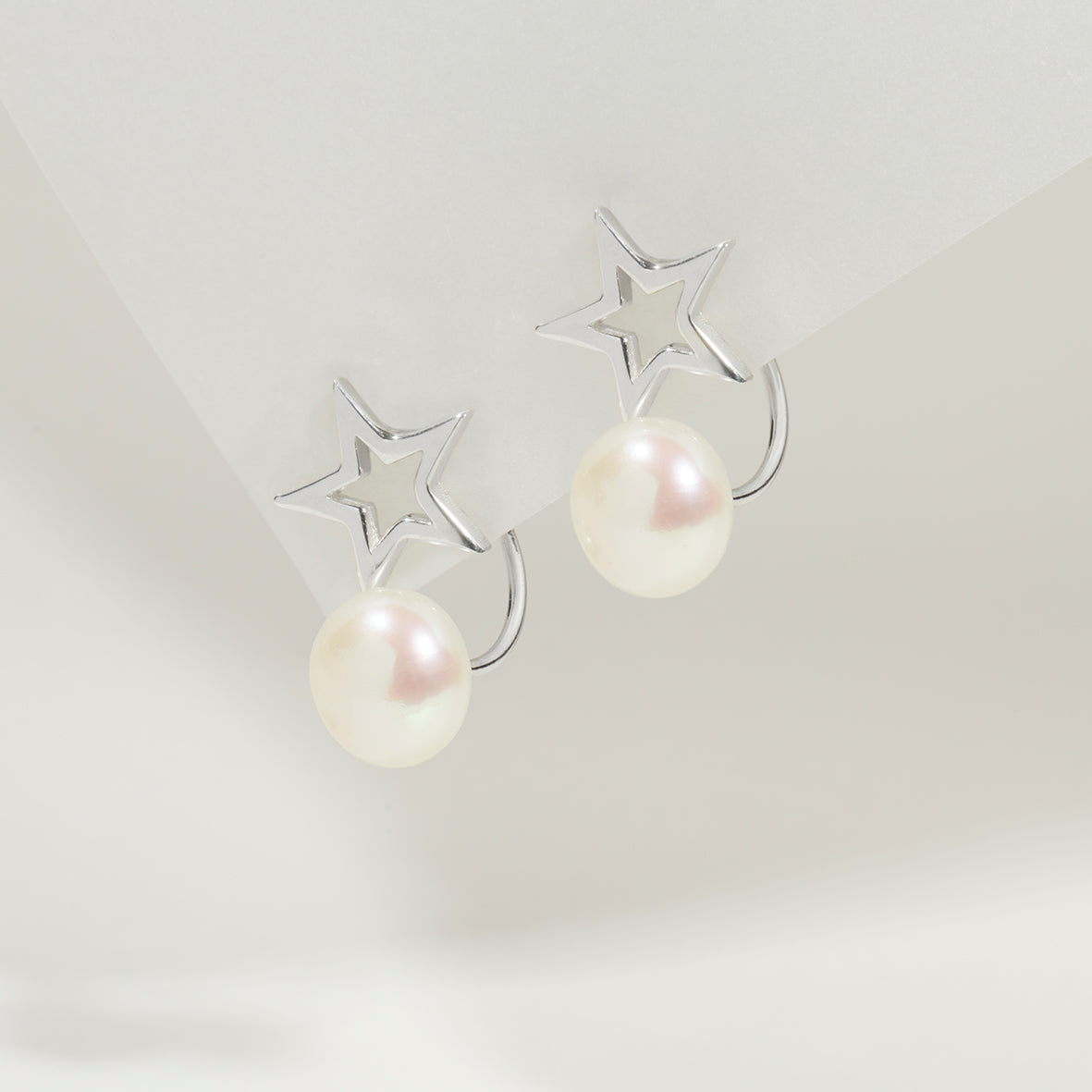 Soremi’s Star Pearl Ear Jackets displayed with the sterling silver star and pearl combination.