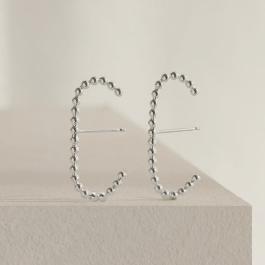 A pair of our sterling silver dot cuff earrings.