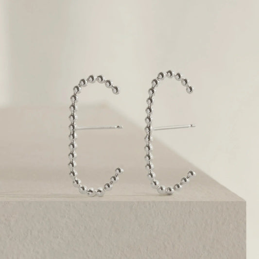 A pair of our sterling silver dot cuff earrings.