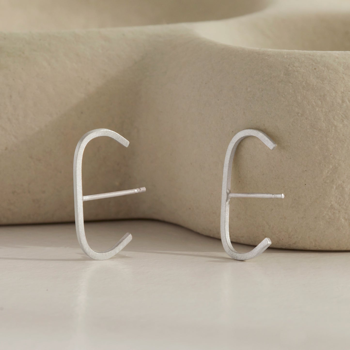 A pair of our sterling silver slim cuff earrings.