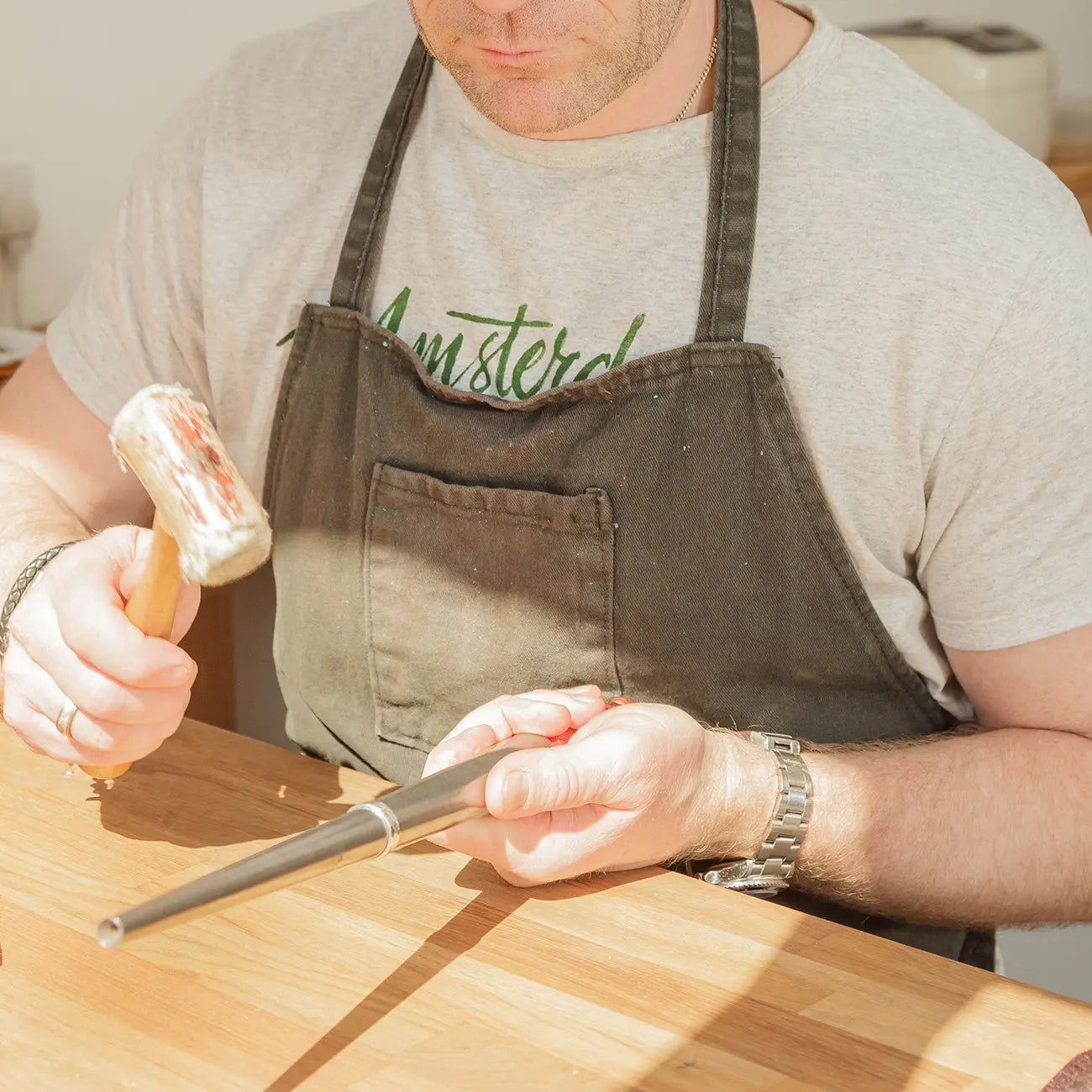 Hands shaping a wedding band during a jewellery workshop in Leeds