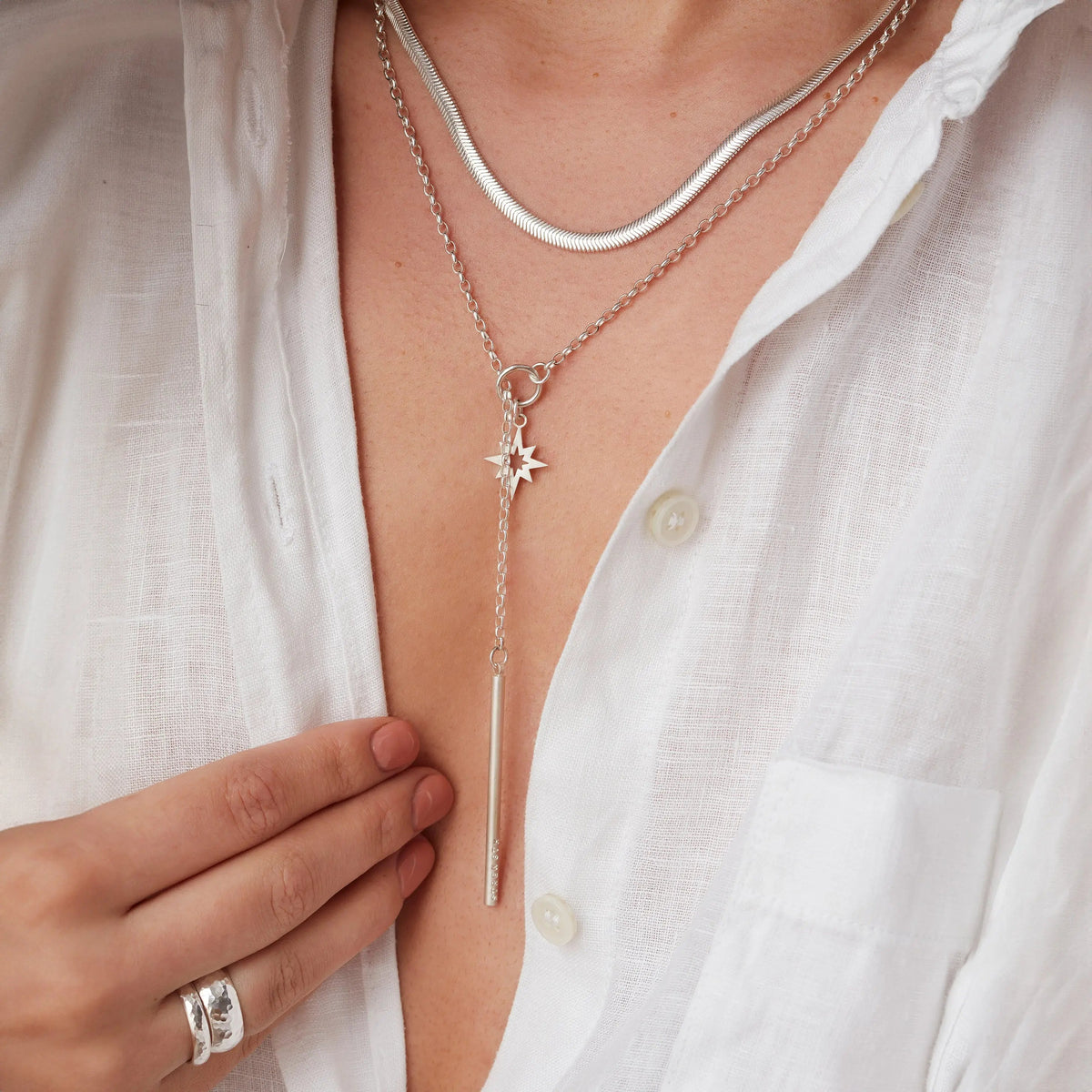Layered necklaces worn together including the personalised lariat necklace with silver star charm