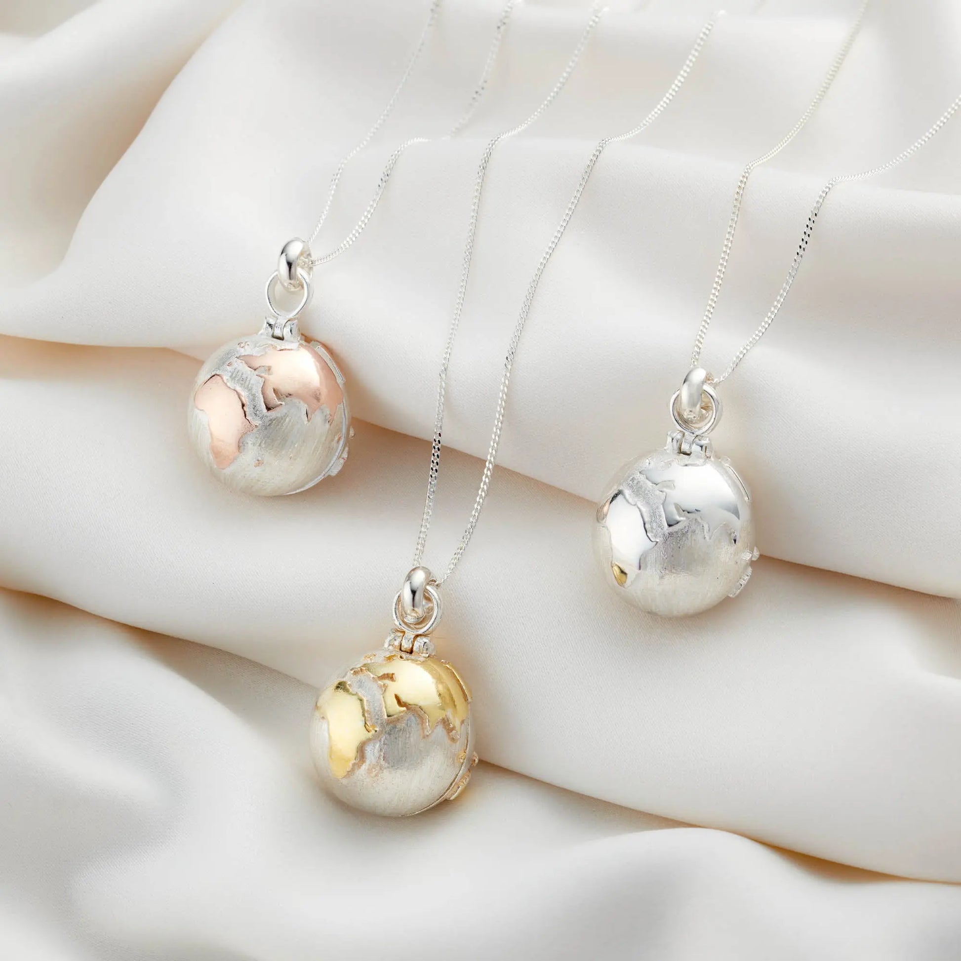 Personalised globe locket necklaces in silver with rose and yellow gold-plated accents
