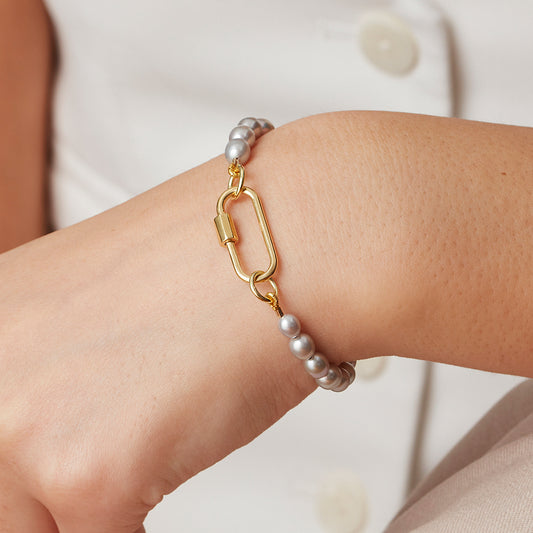 Lustrous grey pearl beaded bracelet with a large gold vermeil carabiner charm.
