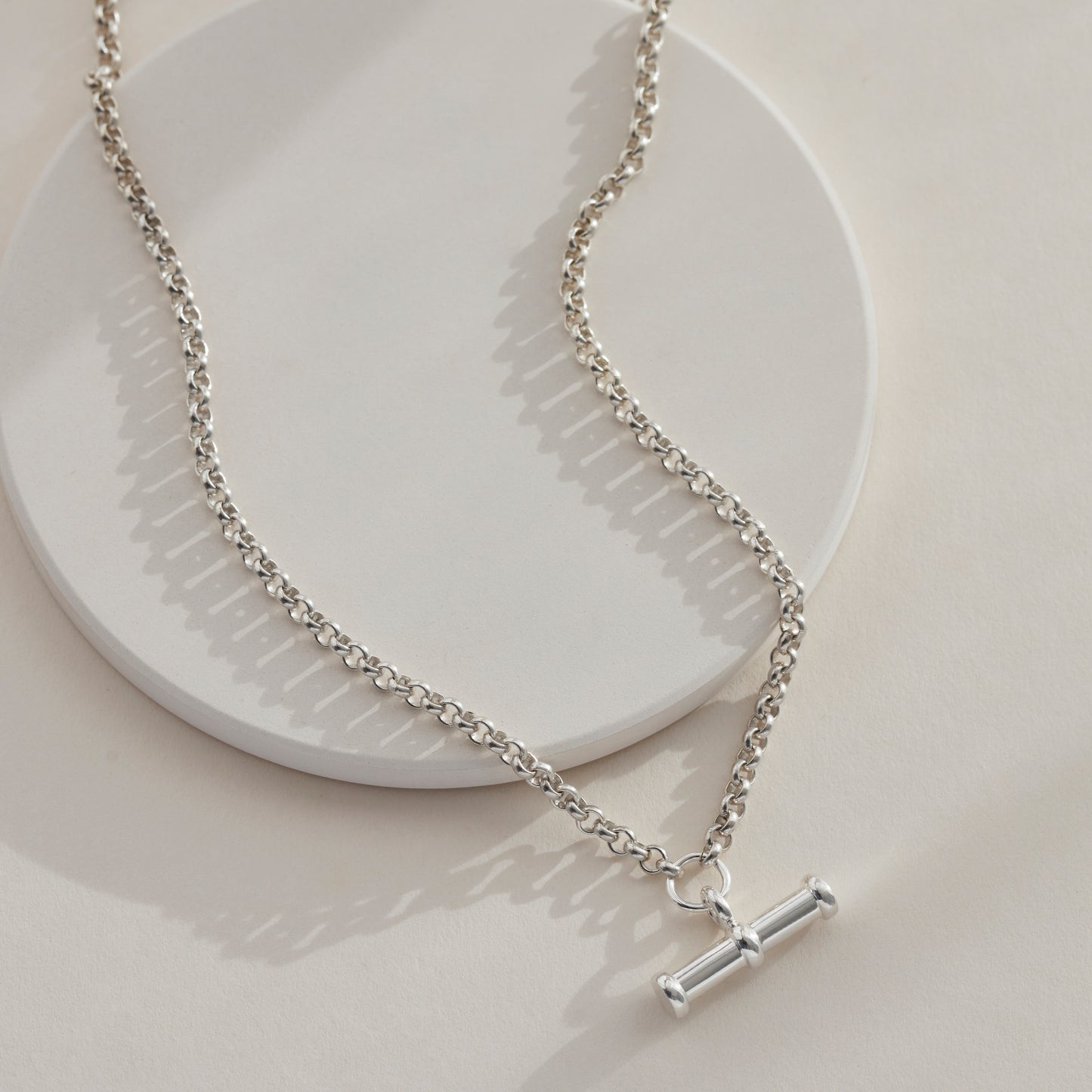 Silver T Bar Necklace Laid on a flat surface