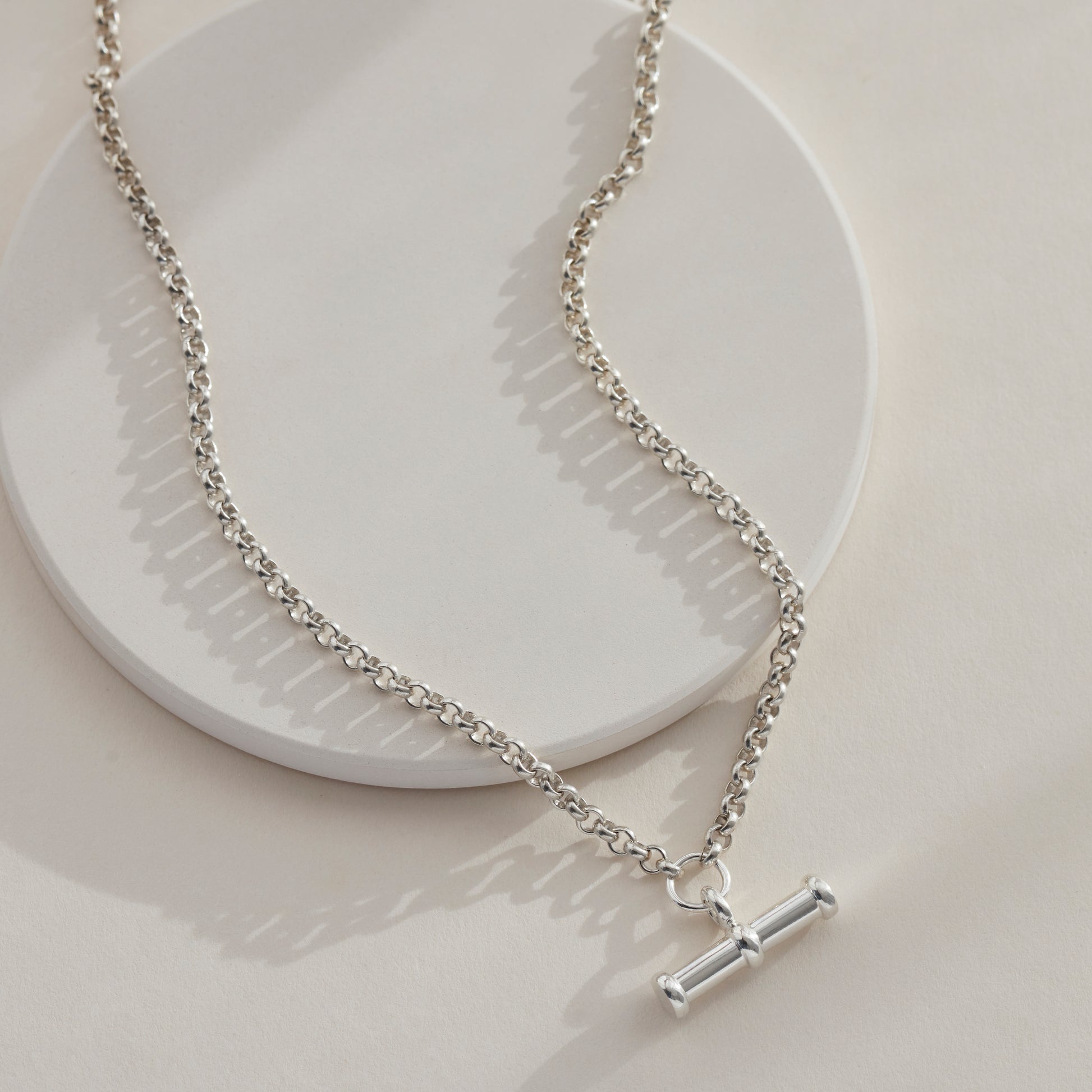 Silver T Bar Necklace Laid on a flat surface