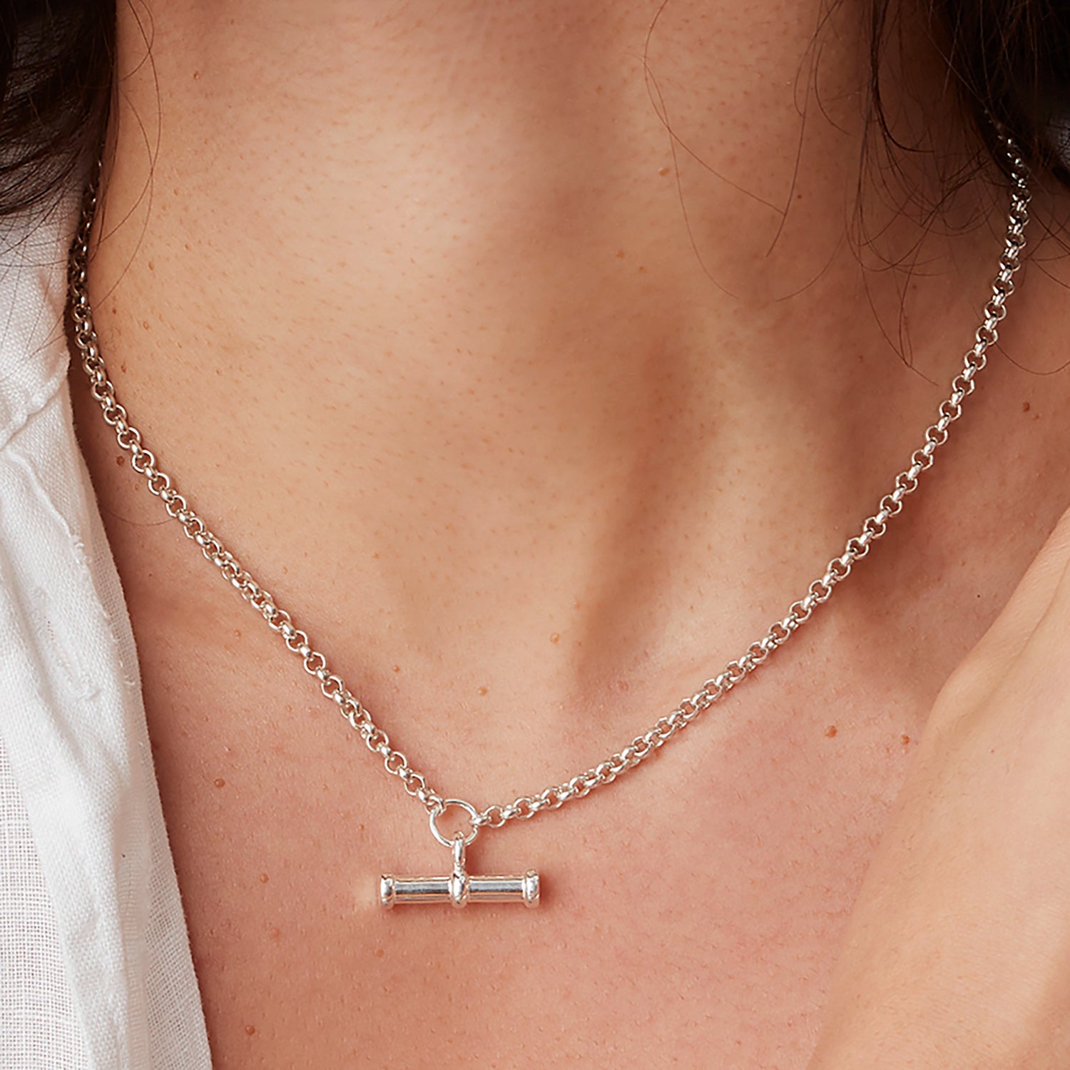 Close up of model wearing silver T-Bar necklace on a 16" chain
