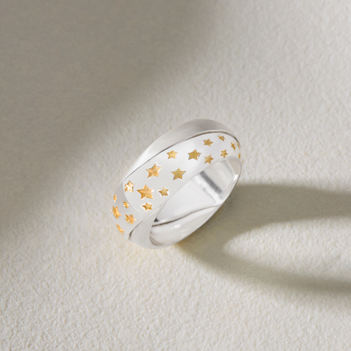 Personalised Möbius ring in sterling silver with polished and matt finishes and gold stars