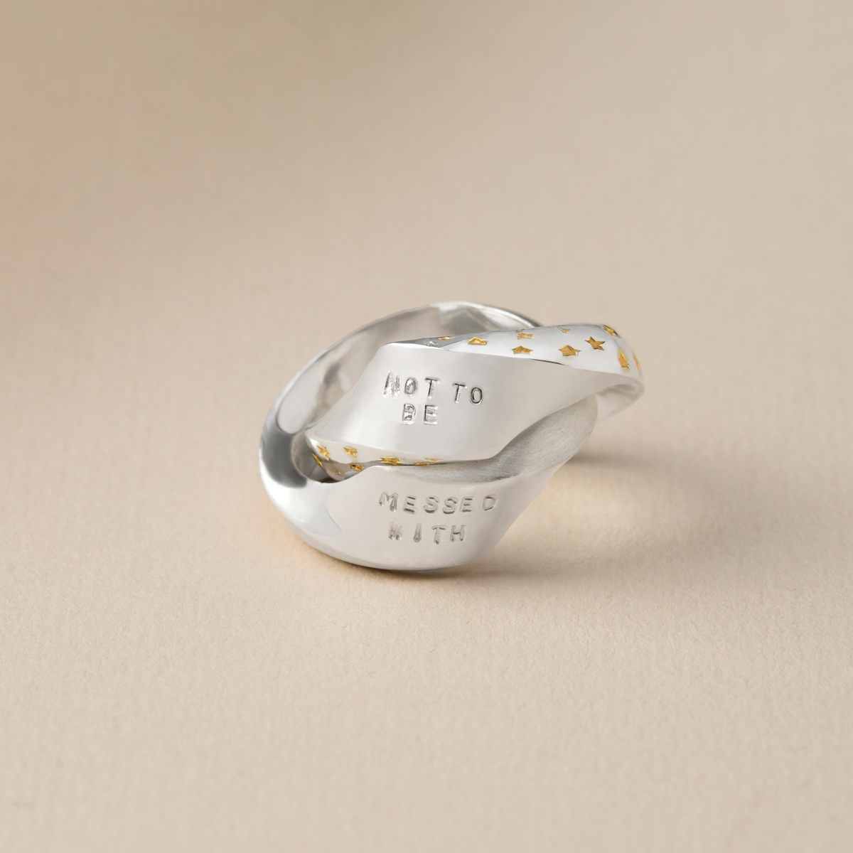 Hidden message Möbius ring opened to show personalised hand-stamped words inside