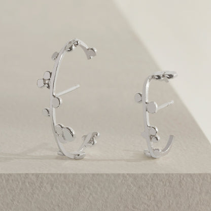 Silver cuff earrings with dotted details. 