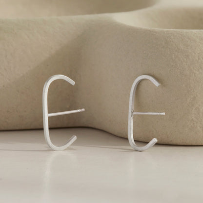 A pair of our sterling silver slim cuff earrings.