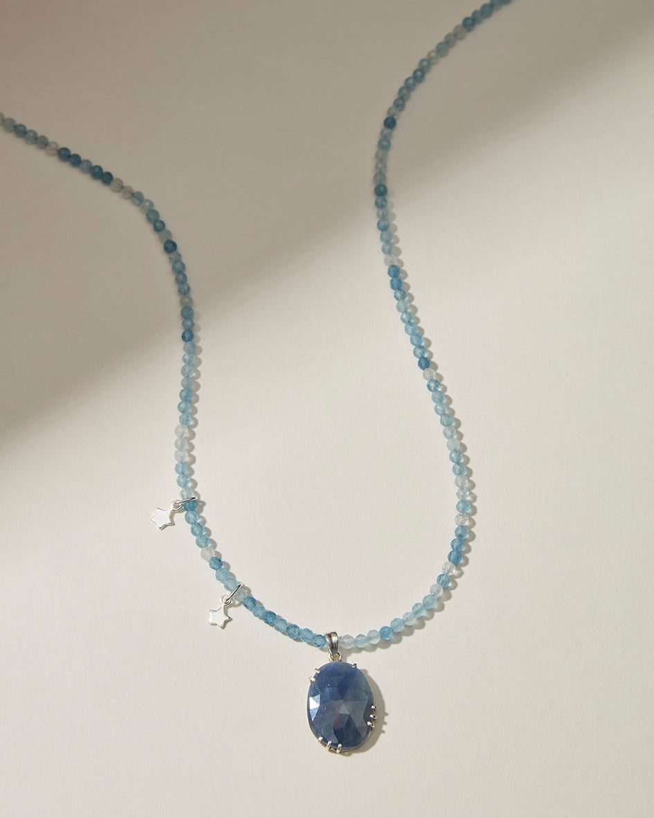 Aquamarine beaded necklace with large blue sapphire pendant and sterling silver star charms