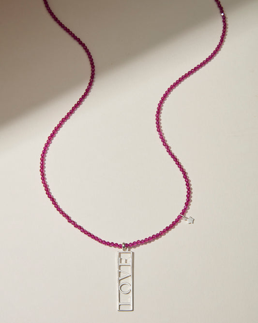 Ruby beaded LOVE necklace with openwork sterling silver pendant and star charm