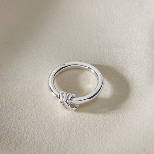 Sterling silver knot ring with hand-wrapped silver detail and polished band