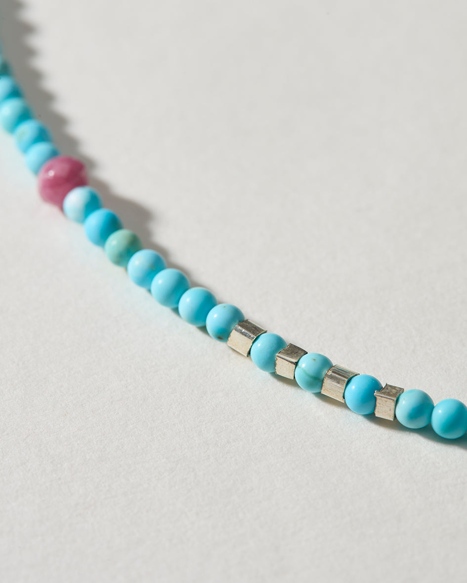Close-up of turquoise gemstone beads with sterling silver spacer beads and pink tourmaline