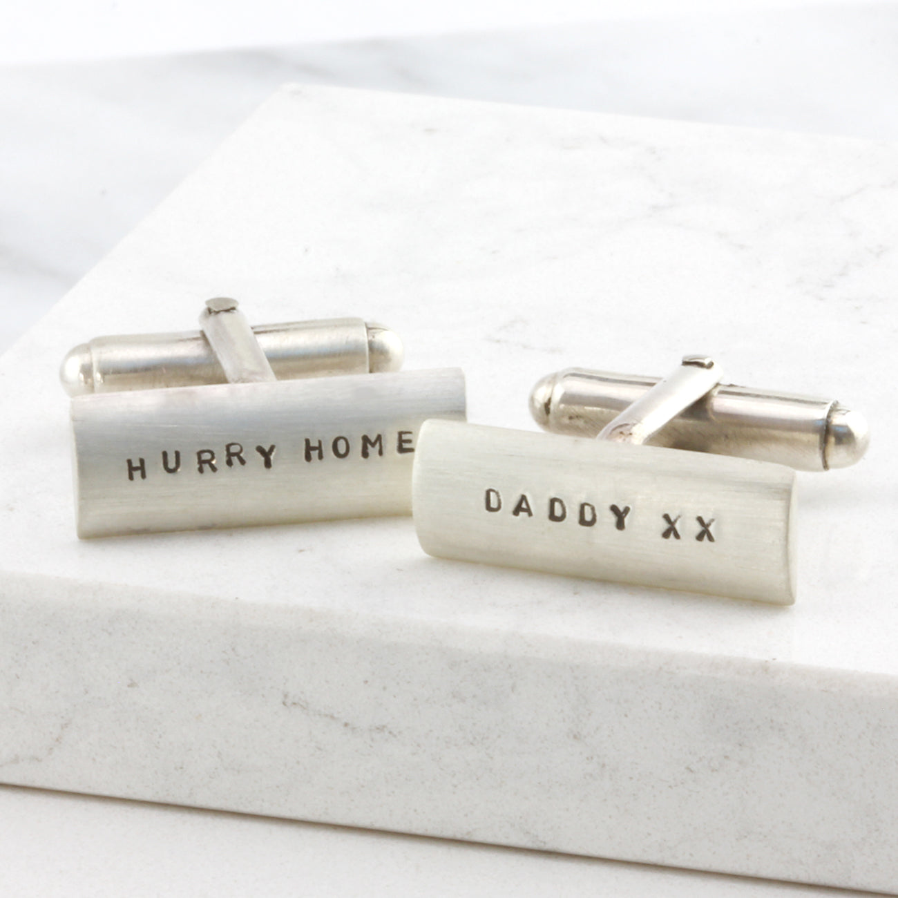 Classic silver cufflinks with custom hand-stamped engraving, displayed on a white background. Engraved with 'Hurry Home' and 'Daddy x x'