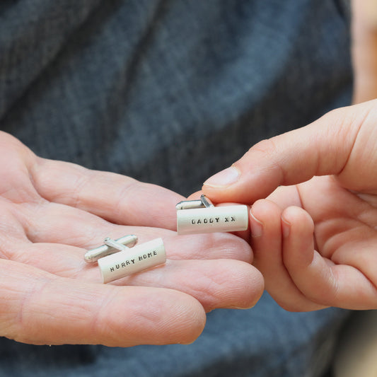 Classic sterling silver personalised cufflinks with bullet-back fasteners. One Cufflink is engraved with 'Hurry Home' and the other 'Daddy x x'