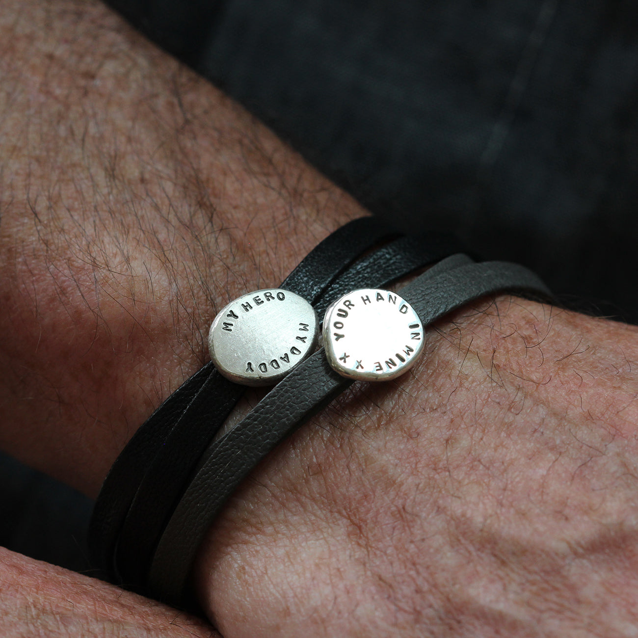 Man wearing personalised Nappa leather bracelet with sterling silver personalised charm..